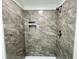 Walk-in shower with gray marble tile and built-in shelves at 861 Savage Rd, Charleston, SC 29414