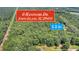 Aerial view of 3.2 acres wooded lot in Johns Island, SC. Property features a home and a pond at 00 Handsome Dr, Johns Island, SC 29455