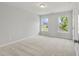 Well-lit bedroom with neutral walls, carpet, and two windows at 2806 Lacy St, North Charleston, SC 29406