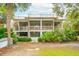 Two-story home with expansive back porch and lush landscaping at 1773 Atlantic Ave, Sullivans Island, SC 29482