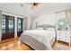 Main bedroom with king-size bed, hardwood floors, and access to private porch at 1773 Atlantic Ave, Sullivans Island, SC 29482