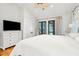 Main bedroom with king-size bed, hardwood floors, and access to private porch at 1773 Atlantic Ave, Sullivans Island, SC 29482