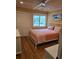 Bright bedroom with a queen bed, bamboo floors, and a large window at 818 Club Cottage Court, Edisto Beach, SC 29438