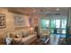 Bright living room with comfy seating, coastal decor, and access to a sunroom at 818 Club Cottage Court, Edisto Beach, SC 29438