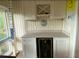 A built-in wet bar with white cabinets, wine rack, and a mini-fridge at 818 Club Cottage Court, Edisto Beach, SC 29438