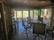 Relaxing screened porch with seating and a view of the backyard at 818 Club Cottage Court, Edisto Beach, SC 29438