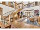 Grand entryway with hardwood floors, curved staircase, and built-in cabinetry at 1408 Palmetto Blvd, Edisto Island, SC 29438