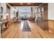 Bright entryway with hardwood floors, a long runner, and wooden built-ins at 1408 Palmetto Blvd, Edisto Island, SC 29438