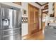 Stainless steel refrigerator in kitchen with wood flooring and cabinetry at 1408 Palmetto Blvd, Edisto Island, SC 29438
