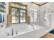 Bathroom with soaking tub, walk-in shower, and wood shutters at 1408 Palmetto Blvd, Edisto Island, SC 29438