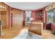 Home office with wood desk, built-in cabinets, and red walls at 1408 Palmetto Blvd, Edisto Island, SC 29438