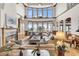 Spacious living room with fireplace, large windows, and comfortable seating at 1408 Palmetto Blvd, Edisto Island, SC 29438
