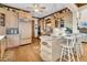 Modern kitchen with island, stainless steel appliances, and light wood cabinets at 1408 Palmetto Blvd, Edisto Island, SC 29438