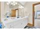 Bathroom with double vanity and large mirror at 1408 Palmetto Blvd, Edisto Island, SC 29438