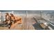 Ocean view deck with wooden chairs and bench at 1408 Palmetto Blvd, Edisto Island, SC 29438