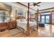 Main bedroom with ocean views, fireplace and a four poster bed at 1408 Palmetto Blvd, Edisto Island, SC 29438