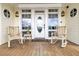 Front porch with rocking chairs, a welcome mat, and an oval glass front door at 1408 Palmetto Blvd, Edisto Island, SC 29438