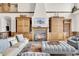 Light-filled living room with a large stone fireplace and built-in shelving at 1408 Palmetto Blvd, Edisto Island, SC 29438