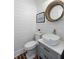 Stylish powder room with shiplap walls and unique mirror at 3583 Somerset Hills Ct, Mount Pleasant, SC 29466