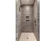 Clean and modern shower with gray tile and pebble floor at 3583 Somerset Hills Ct, Mount Pleasant, SC 29466