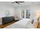 Bright bedroom with dresser, seating area, and view of a private balcony at 3583 Somerset Hills Ct, Mount Pleasant, SC 29466