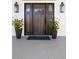 Elegant dark wood front door flanked by planters and lanterns at 3583 Somerset Hills Ct, Mount Pleasant, SC 29466