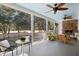 Relaxing screened porch with fireplace, seating area, and golf course views at 3583 Somerset Hills Ct, Mount Pleasant, SC 29466