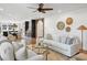 Open living room with hardwood floors, white sofas, and view of kitchen at 3583 Somerset Hills Ct, Mount Pleasant, SC 29466