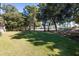 Landscaped backyard with lush green grass and mature trees at 3583 Somerset Hills Ct, Mount Pleasant, SC 29466