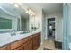 Bathroom with double vanity, large mirror, and tile flooring at 297 Oglethorpe Cir, Moncks Corner, SC 29461