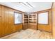 Empty office with wood paneling, built-in shelving, and hardwood floors at 4621 Durant Ave, North Charleston, SC 29405