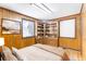 Bedroom with wood paneling, hardwood floors, and built-in shelving at 4621 Durant Ave, North Charleston, SC 29405