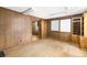 Empty office space with wood paneling, hardwood floors, and built-in shelving at 4621 Durant Ave, North Charleston, SC 29405