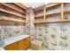 Office with wood paneling, built-in shelving, and hardwood floors at 4621 Durant Ave, North Charleston, SC 29405