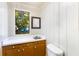 Small bathroom with wood paneling, a sink, and toilet at 4621 Durant Ave, North Charleston, SC 29405