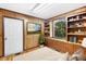 Cozy bedroom with wood paneling, built-in shelving, and hardwood floors at 4621 Durant Ave, North Charleston, SC 29405