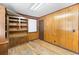 Spacious office featuring wood paneling, built-in shelving, and hardwood floors at 4621 Durant Ave, North Charleston, SC 29405