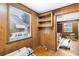 Office with wood paneling, built-in shelving, hardwood floors, and a window at 4621 Durant Ave, North Charleston, SC 29405