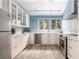 L-shaped kitchen with white cabinets, stainless steel appliances, and blue walls at 1712 Live Oak Park, Seabrook Island, SC 29455