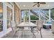 Relaxing screened porch with table and seating area, perfect for outdoor dining at 1000 Rivershore Rd, Charleston, SC 29492