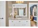 Vanity with granite countertop, framed mirror and white cabinets at 1000 Rivershore Rd, Charleston, SC 29492