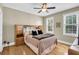 Bedroom with a queen-size bed, wooden headboard, and hardwood floors at 1000 Rivershore Rd, Charleston, SC 29492