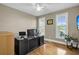 Home office with a large desk, hardwood floors, and two windows at 1000 Rivershore Rd, Charleston, SC 29492