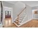 Elegant staircase with hardwood floors and white railings at 1000 Rivershore Rd, Charleston, SC 29492