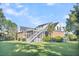 Brick house with a large deck and screened porch, offering a tranquil backyard view at 1000 Rivershore Rd, Charleston, SC 29492