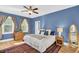 Bright bedroom with a queen-size bed, wooden dresser, and two windows at 1000 Rivershore Rd, Charleston, SC 29492