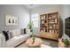 Modern living room with light sofa, wood shelving and coffee table at 307 Trailmore Ln, Summerville, SC 29486