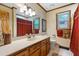 Bathroom with wood vanity, red accents, and hexagon tile floor at 1610 Dennis Blvd, Moncks Corner, SC 29461