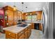 Bright kitchen with oak cabinets, tile counters, and stainless steel appliances at 1610 Dennis Blvd, Moncks Corner, SC 29461