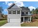 Two-story gray house with white garage door and black shutters at 2802 Lacy St, North Charleston, SC 29406